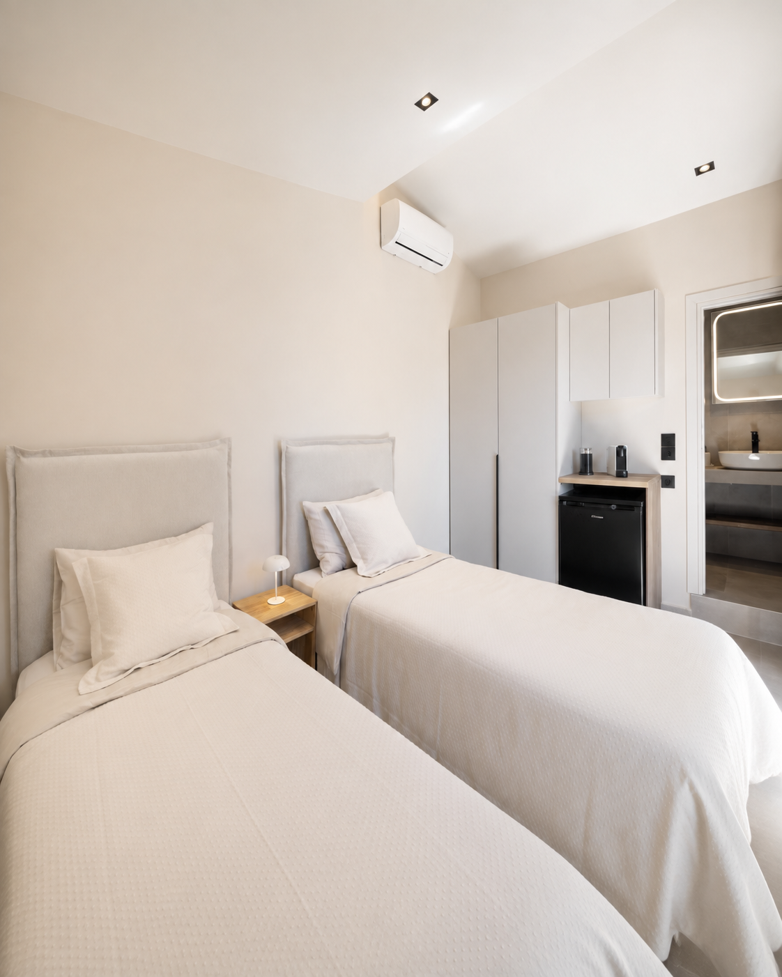 Twin bedroom with minibar at a luxury villa in Athens Riviera