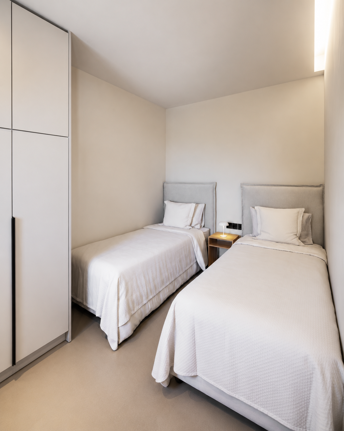 Modern twin bedroom with two single beds at a private villa in Athens Riviera